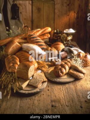 Selection of breads, breadboard and flour, Winkfield, Berkshire, England, United Kingdom Stock Photo