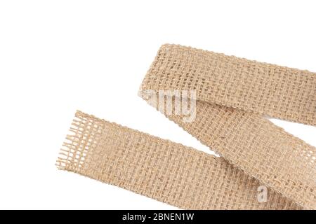 Burlap Fabric Wide rustic ribbon, Sackcloth Piece of Linen Jute, Sack Cloth Tag Isolated on White background . Decoration element. Stock Photo