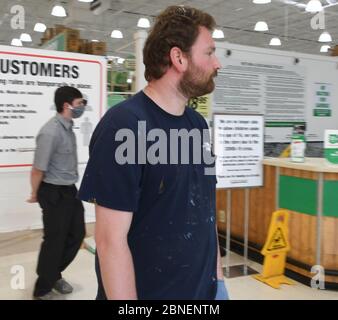 Mount Pleasant, Wisconsin, USA. 14th May, 2020. A security guard enforces the rule at the Menard's home improvement store in the Village of Mount Pleasant, Wisconsin Thursday May 14, 2020 that all customers including this one must wear masks. Customers without masks are directed to buy one at the customer service counter. This man was heard to say that he would go to a competing store instead. The Menard's chain has been open throughout the Coronavirus crisis, but has recently started requiring masks. There is customer uncertainty in Wisconsin about businesses reopening during the Coronavi Stock Photo