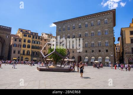 Florence, Italy - August 16, 2019: Mulberry tree in a dodecahedron and Palazzo delle Assicurazioni Generali in the Piazza della Signoria in Florence Stock Photo