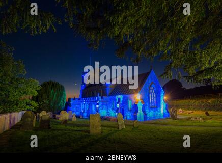 Broadwindsor, Dorset, UK.  14th May 2020.  St John the Baptist  Church at Broadwindsor in Dorset is lit blue in tribute to the NHS, Frontline Staff and Key Workers.  This is the second in the series of local churches to be lit up blue for the NHS with a different one to be lit every thurday.  Picture Credit: Graham Hunt/Alamy Live News Stock Photo