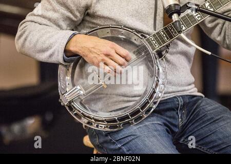 Close up of hands playing banjo Stock Photo