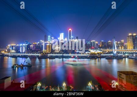 --FILE--An aerial view of skyscrapers standing in the city center along the river at night, Chongqing, China, 6 March 2016. (Edited photo) Zhou Zhiyon Stock Photo