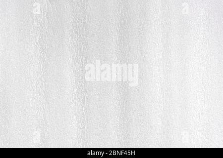 Foam white plastic texture. Styrofoam abstract grey surface with grain structure. Synthetic material for packing. Horizontal view, close up, macro. Stock Photo