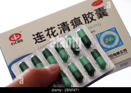 In this unlocated photo, a customer holds a box of Lianhua Qingwen capsule, 14 April 2020. Lianhua Qingwen capsule/capsule is a patented new drug for Stock Photo