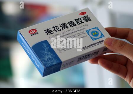 In this unlocated photo, a customer holds a box of Lianhua Qingwen capsule, 14 April 2020. Lianhua Qingwen capsule/capsule is a patented new drug for Stock Photo