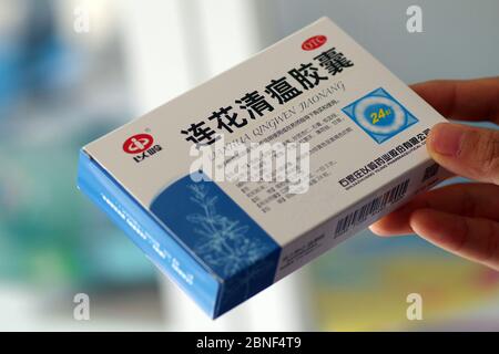 In this unlocated photo, a customer holds a box of Lianhua Qingwen capsule, 14 April 2020. Lianhua Qingwen capsule/capsule is a patented new drug for Stock Photo