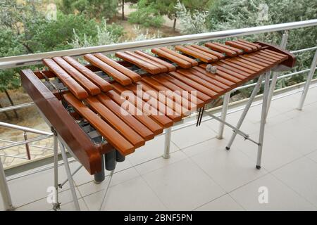 Xylophone, weenote. Xylophone closeup, wooden percussion instrument green backgrounds .Thai wooden alto xylophone instrument. Wooden xylophone in a Stock Photo