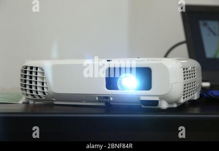 LCD video projector at business conference or lecture in office with copy space. projector on ceiling indoors. LCD video projector at business Stock Photo