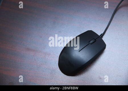 Mouse Red furniture on the table . A black computer mouse . Stock Photo