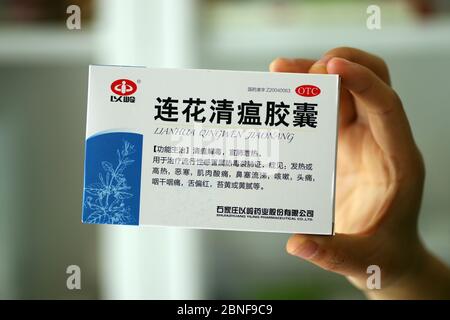 In this unlocated photo, a customer holds a box of Lianhua Qingwen capsule, 14 April 2020. Lianhua Qingwen capsule/capsule is a patented new drug for Stock Photo