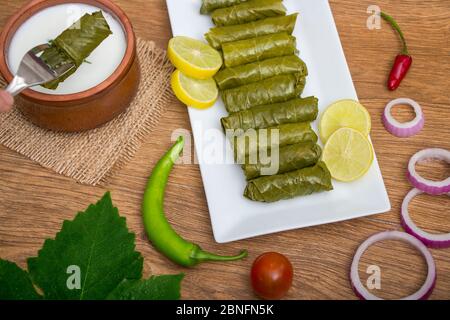 Mahshi or Mahshy - Egyptian traditional cuisine - Grape leaves stuffed rolls with yogurt Stock Photo