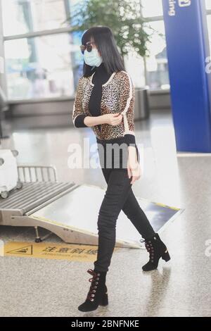 Chinese television and film actress Tan Zhuo arrives at a Chengdu airport before departure in Chengdu city, southwest China's Sichuan province, 14 Apr Stock Photo