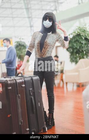 Chinese television and film actress Tan Zhuo arrives at a Chengdu airport before departure in Chengdu city, southwest China's Sichuan province, 14 Apr Stock Photo