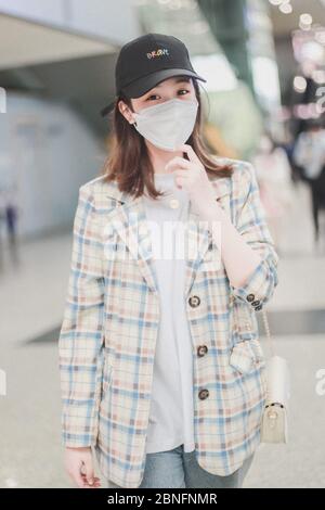 Chinese actress Yan Zhichao arrives at a Chengdu airport before departure in Chengdu city, southwest China's Sichuan province, 12 April 2020. Stock Photo