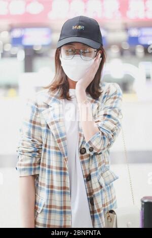 Chinese actress Yan Zhichao arrives at a Chengdu airport before departure in Chengdu city, southwest China's Sichuan province, 12 April 2020. Stock Photo