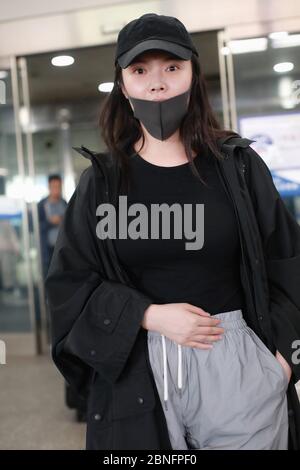 Chinese actress and singer Xu Dongdong arrives at a Beijing airport ...