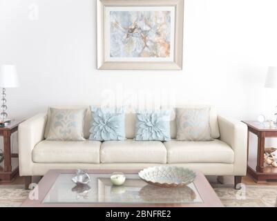 Living room with white sofa, coffee table and painting on wall Stock Photo