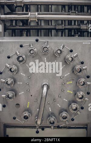 Vertical grayscale shot of a stainless steel machine tool Stock Photo