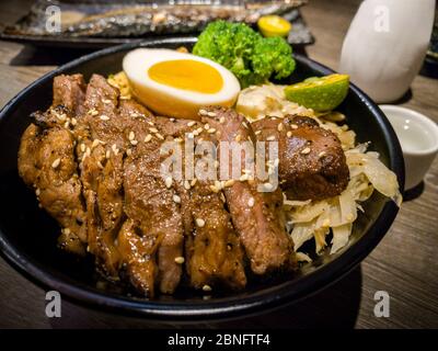 Set of delicious traditional skewers grilled and rice bowl of donburi for dinner. Popular Japanese variety food in the restaurant. Appetizing Japan ka Stock Photo