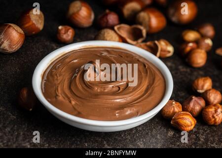 Sweet hazelnut spread. Chocolate cream in bowl. Stock Photo