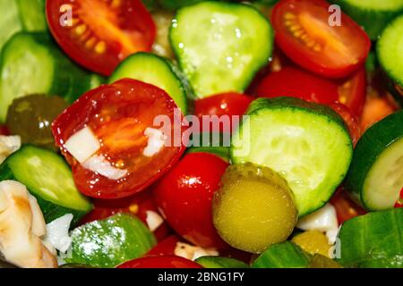 Vegetable salad sliced tomatoes, cucumbers, onions and pickles. Close up. Healthy food, fitness diet Stock Photo