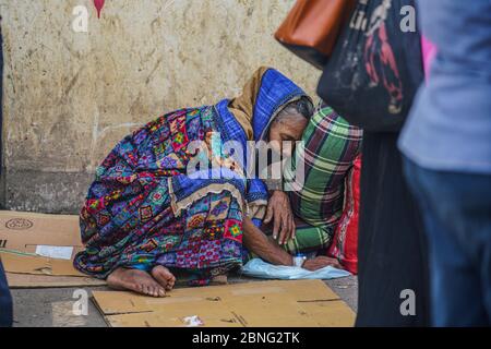 Dhaka, Bangladesh. 13th May, 2020. An exhausted elderly lady waiting in queue while wearing a face mask as a precaution during the tests. Bangabandhu Sheikh Mujib Medical University Hospital is carrying out covid 19 tests on Bangladeshi people as health ministry records 19904 confirmed cases, 3361 recovered and 297 deaths by the corona virus. Credit: SOPA Images Limited/Alamy Live News Stock Photo