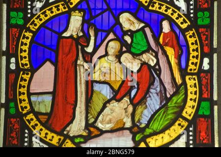 A Victorian stained glass window depicting the baby Moses being discovered in his basket amid bullrushes on the River Nile by the Princess daughter of Stock Photo