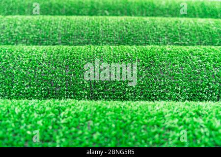 Artificial grass lawn texture. Artificial Turf Background. Greenering with an artificial grass. Rolled artificial turf laying background texture. Roll Stock Photo