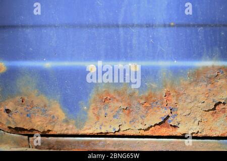 Fragment of an old rusted blue car close-up. Abstract background Stock Photo