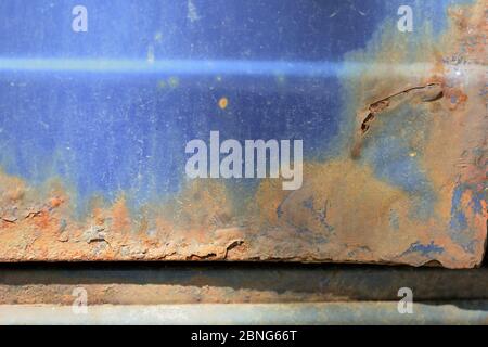 Fragment of an old rusted blue car close-up. Abstract background Stock Photo