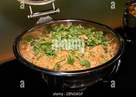 Asian style fried rice with vegetables on top on a large buffet pan. Stock Photo