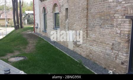 Building old stone wall in the city Stock Photo