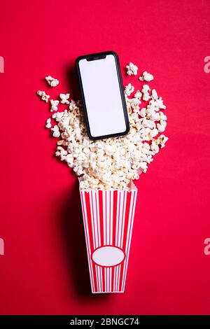 LONDON, UK - MAY 14 2020: Apple iphone blank screen with cinema popcorn Stock Photo