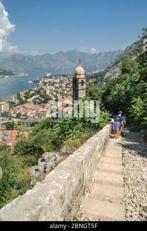 A panoramic view of the Bay of Kotor, cruise port, mountains and the medieval walled old town from the ruins of the Castle of San Giovanni Stock Photo