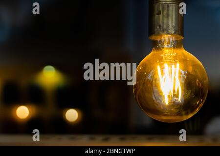 old retro vintage incandescent light bulb. loft style. ideas concept. bokeh background and copy space. Stock Photo