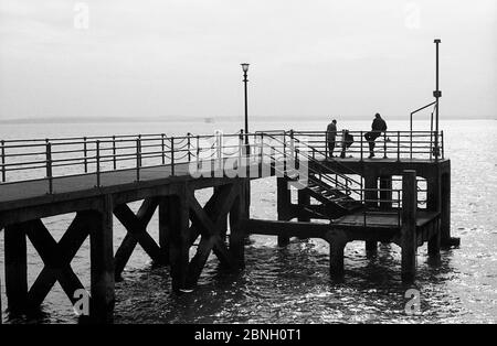 Fishing from an old jetty by the Hot Walls, Portsmouth Harbour entrance Stock Photo