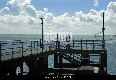 Fishing from an old jetty by the Hot Walls, Portsmouth Harbour entrance Stock Photo