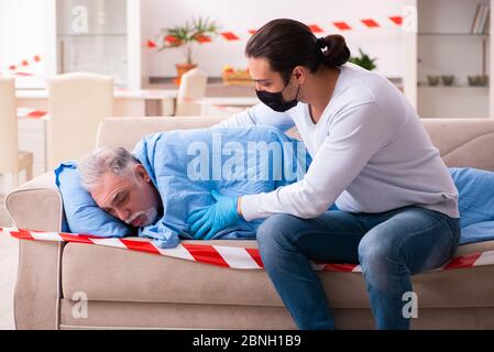 Father and son in the coronavirus concept at home Stock Photo