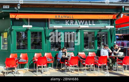 People have lunch in a restaurant of the famous area of the market Naschmarkt in Vienna, Austria. The popular Naschmarkt has existed since the 16th ce Stock Photo