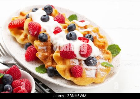 Delicious belgian waffles with ice cream and summer berries. With copy space Stock Photo