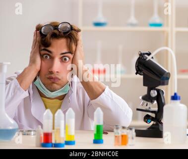 The funny crazy chemist doing experiments and tests Stock Photo