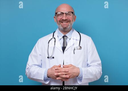 Smiling mature doctor in white coat and stethoscope Stock Photo