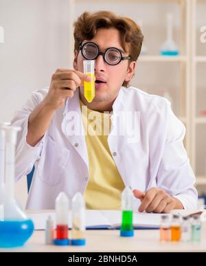 The funny crazy chemist doing experiments and tests Stock Photo