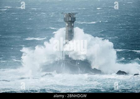 Big waves breaking over Longships Lighthouse, Land's End, Cornwall, England, UK. December 2014. Stock Photo