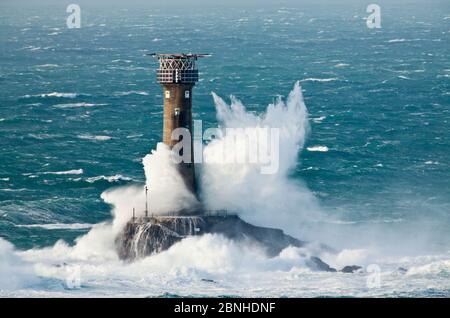 Big waves breaking over Longships Lighthouse, Land's End, Cornwall, England, UK. November 2009. Stock Photo