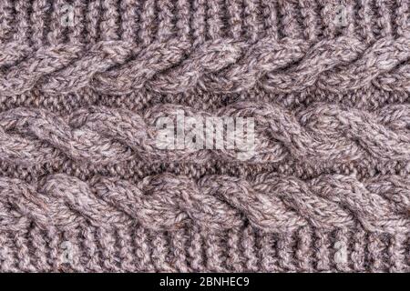 Wool grey knitted texture. Woolen gray cloth, handmade. Textile ornament. Fashion knitwear. Light wool yarn. Fabric texture. Winter scarf. Seamless pa Stock Photo
