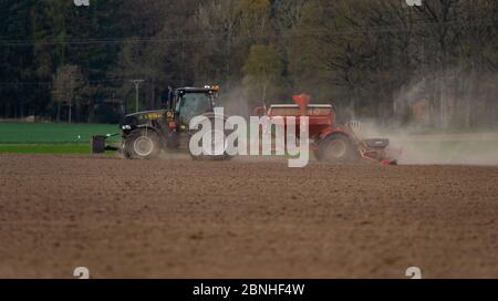 Ebstorf, Germany. 15th Apr, 2020. An agricultural contractor sows maize in a field and kicks up dust. Credit: Philipp Schulze/dpa/Alamy Live News Stock Photo