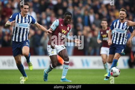 Aston Villa's Keinan Davis gets his pass away as he is challenged by Brighton and Hove Albion's Lewis Dunk, during the Premier League match at Villa Park, Birmingham.