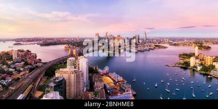 Sydney harbour, CBD, lower north shore and major city landmakrs around Lavender bay in aerial panorama at sunrise. Stock Photo